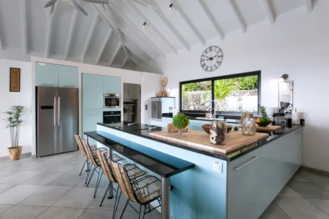 a dining hall with stainless steel appliances a sink and a large window