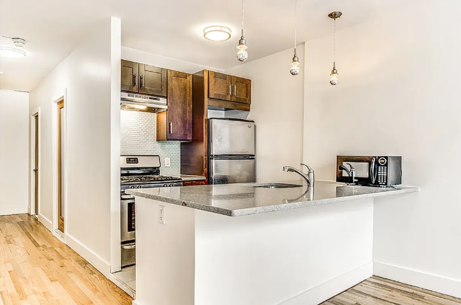 406 Monroe Street, Unit 3 Brooklyn, NY 11221 - Photo 2 of 11 a kitchen with stainless steel appliances granite countertop a refrigerator and a sink