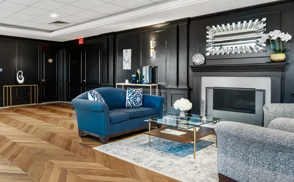 a living room with furniture a fireplace and a projector