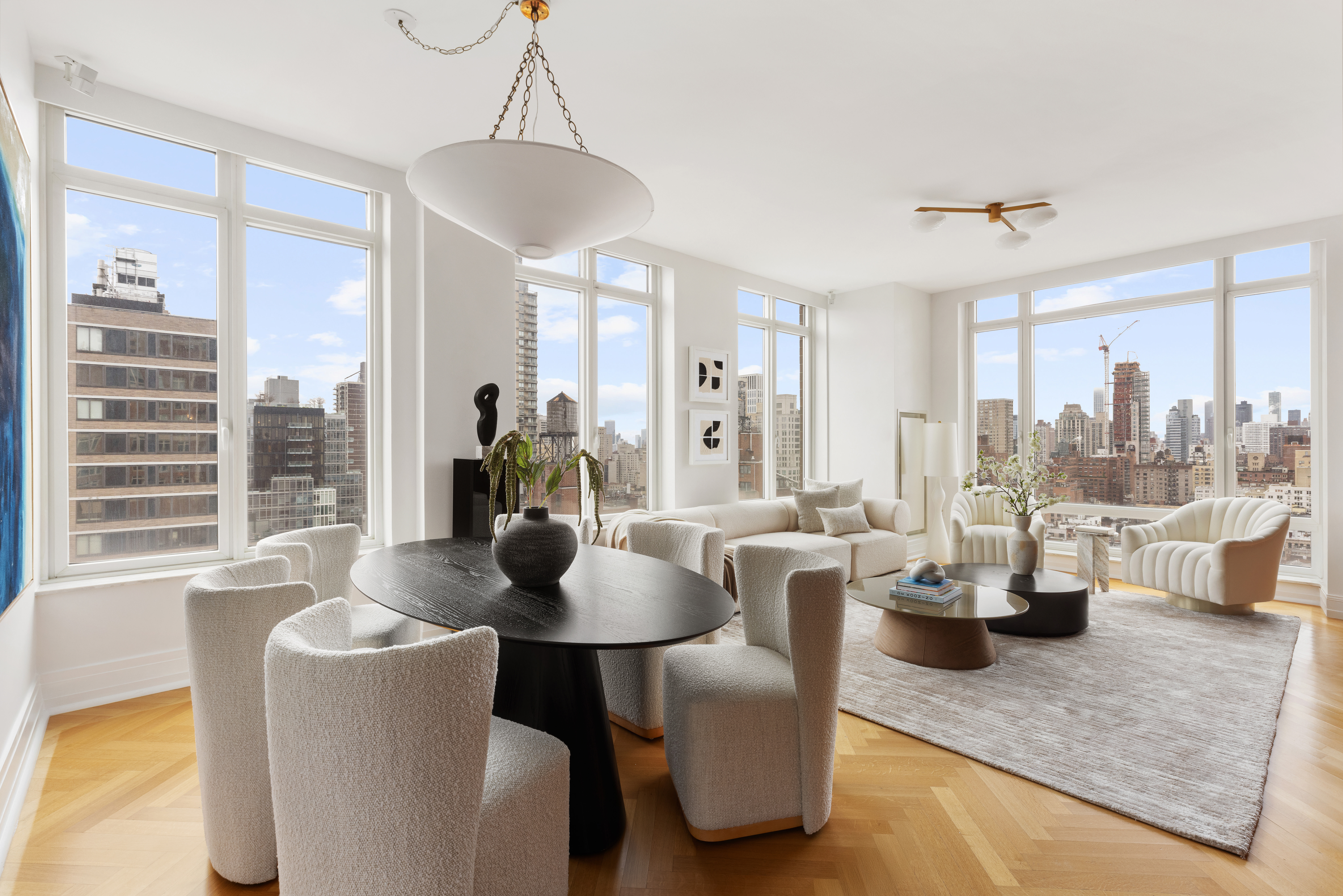 a living room with couches a coffee table and a chandelier