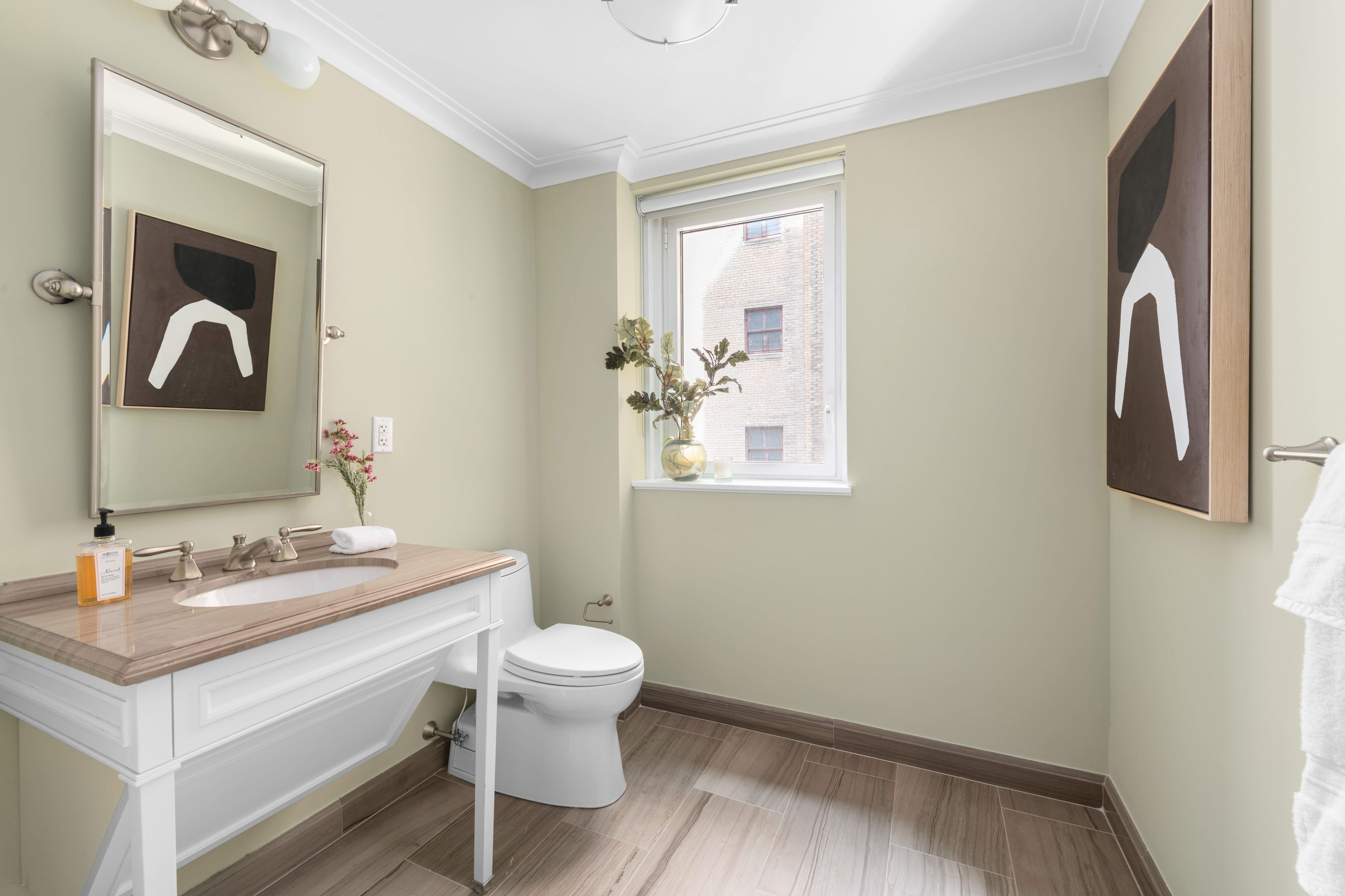 530 Park Avenue, Unit 12F Manhattan, NY 10065 - Photo 18 of 26 a bathroom with a sink and a mirror