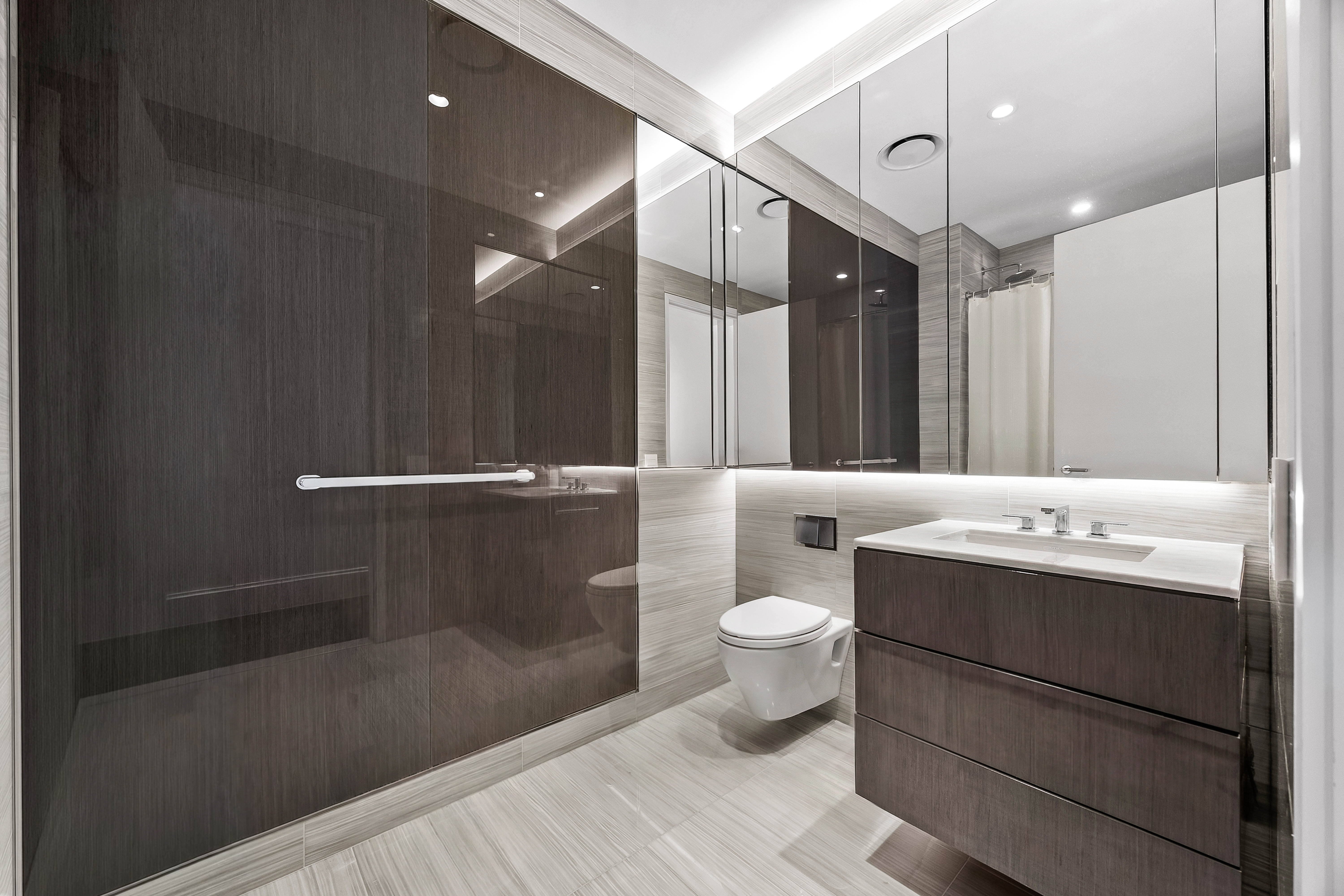 217 West 57th Street, Unit 36D Manhattan, NY 10019 - Photo 14 of 26 a bathroom with a sink a toilet and shower