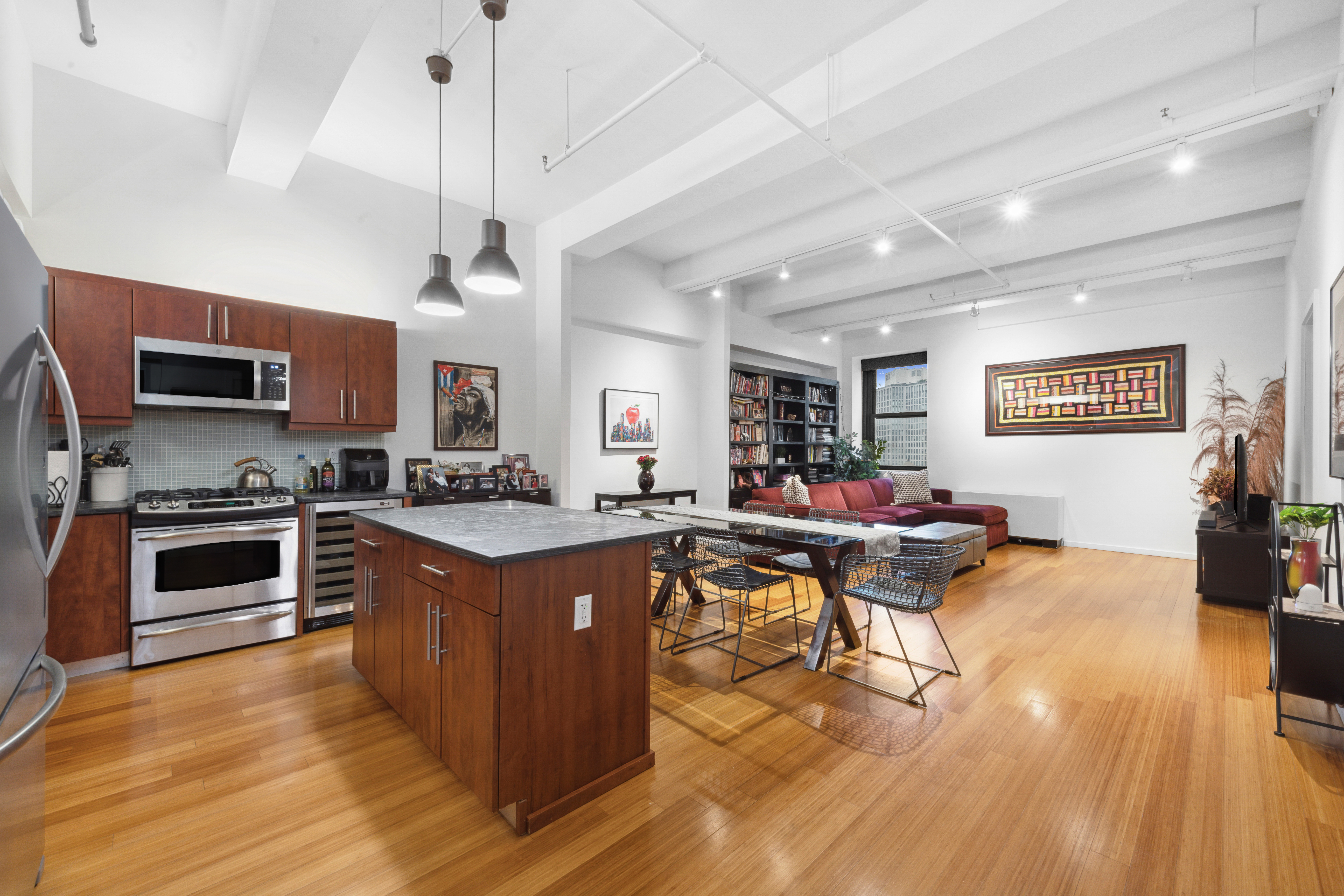 a kitchen with stainless steel appliances granite countertop a stove cabinets and wooden floor