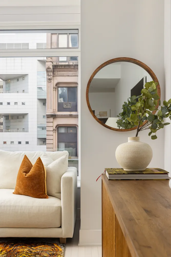 a living room with furniture and a potted plant