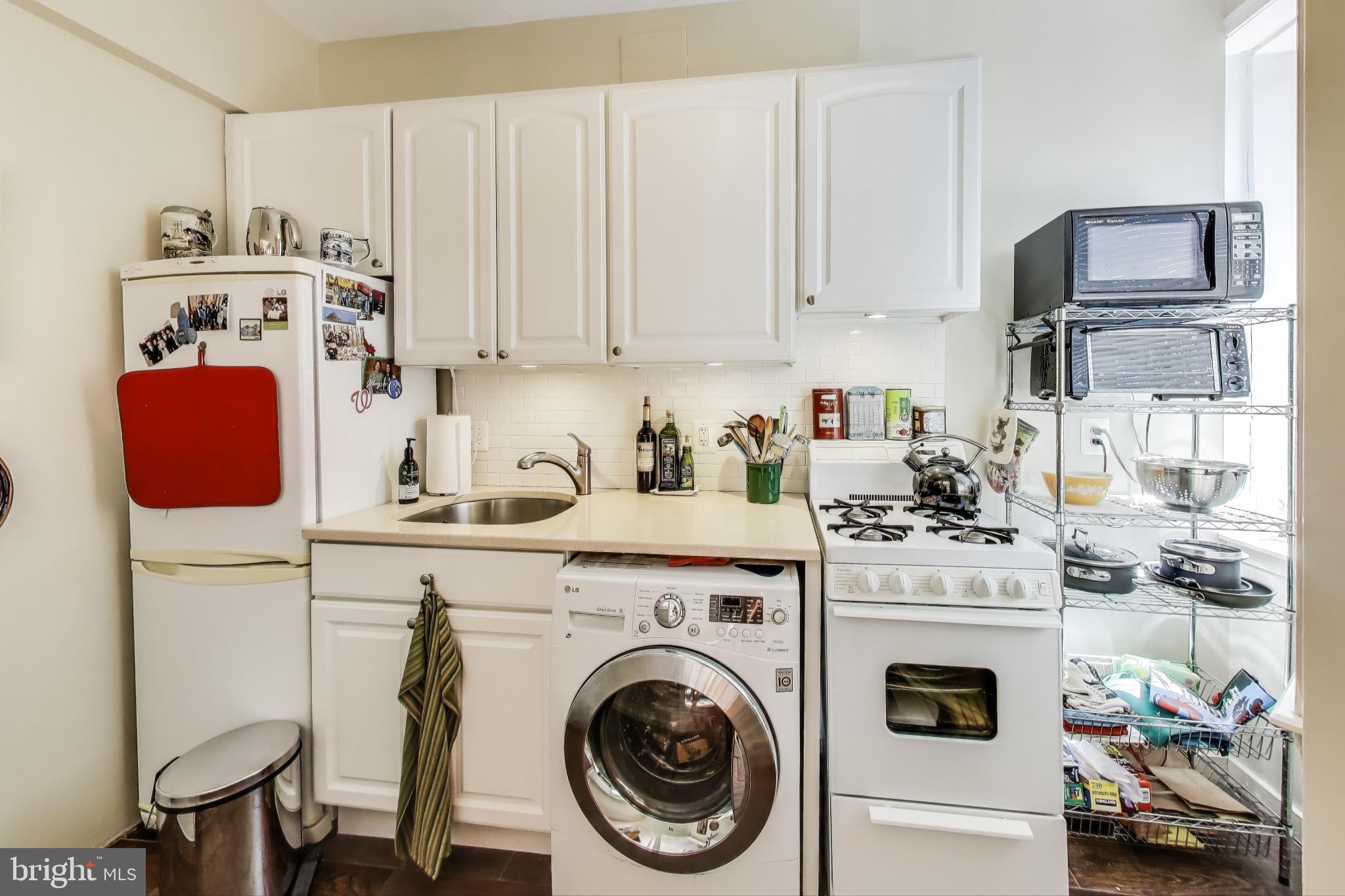 1317 Corcoran Street Northwest Washington, DC 20009 - Photo 12 of 47 a view of kitchen sink washer and dryer