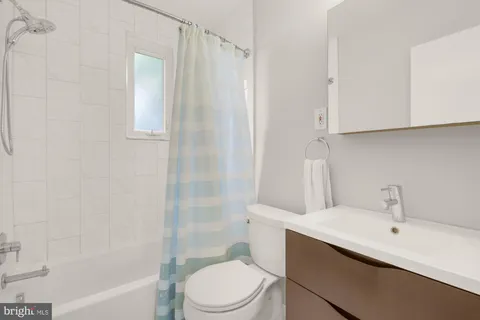 a bathroom with a toilet a sink and bathtub