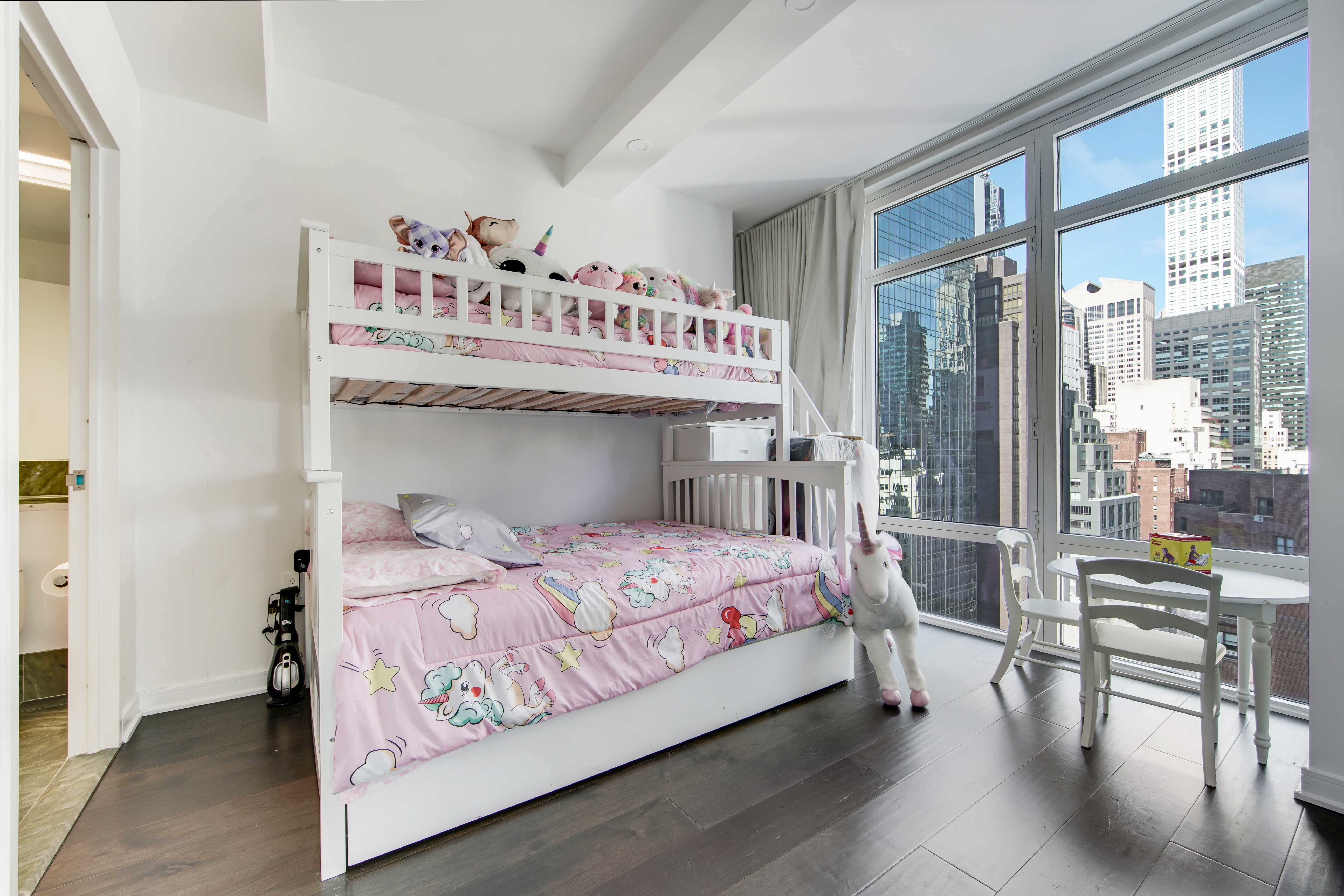 207 East 57th Street, Unit 20A Manhattan, NY 10022 - Photo 13 of 18 a bedroom with a bed and a table