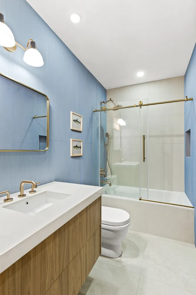 a bathroom with a sink a toilet and a large mirror