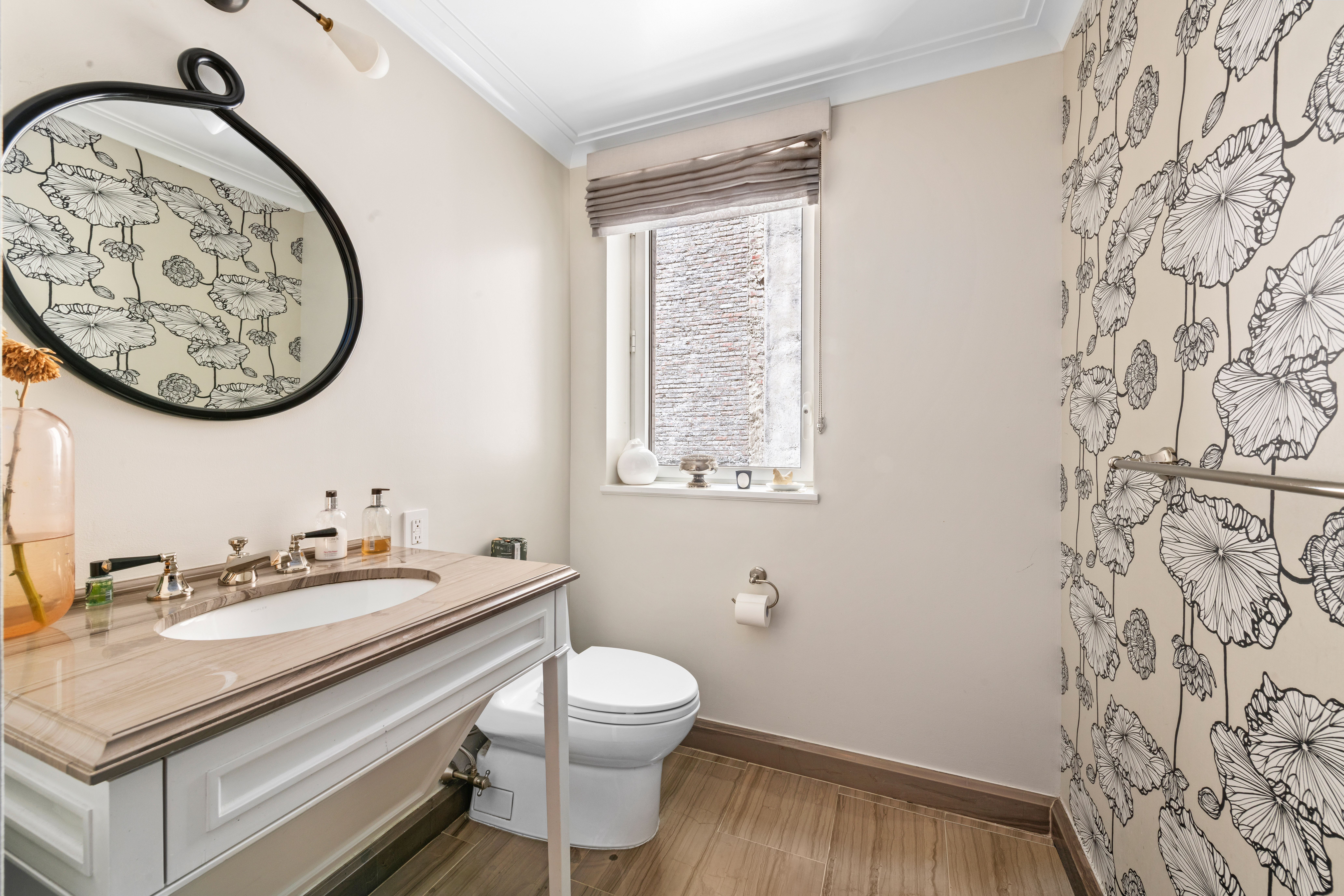 530 Park Avenue, Unit 3F Manhattan, NY 10065 - Photo 19 of 25 a bathroom with a toilet a sink and a mirror