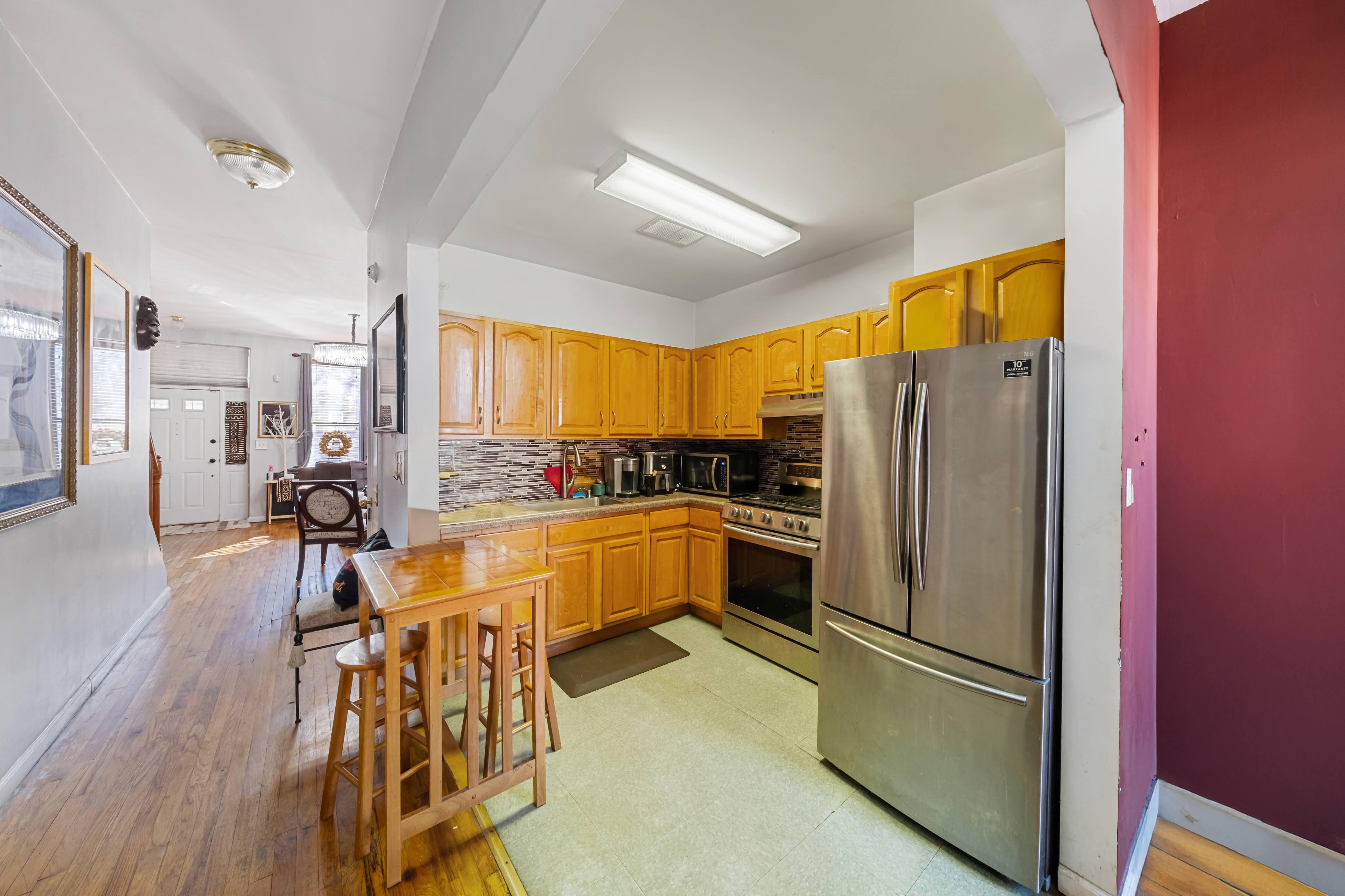 275 Van Buren Street Brooklyn, NY 11221 - Photo 4 of 33 a kitchen with stainless steel appliances granite countertop a refrigerator and a stove top oven