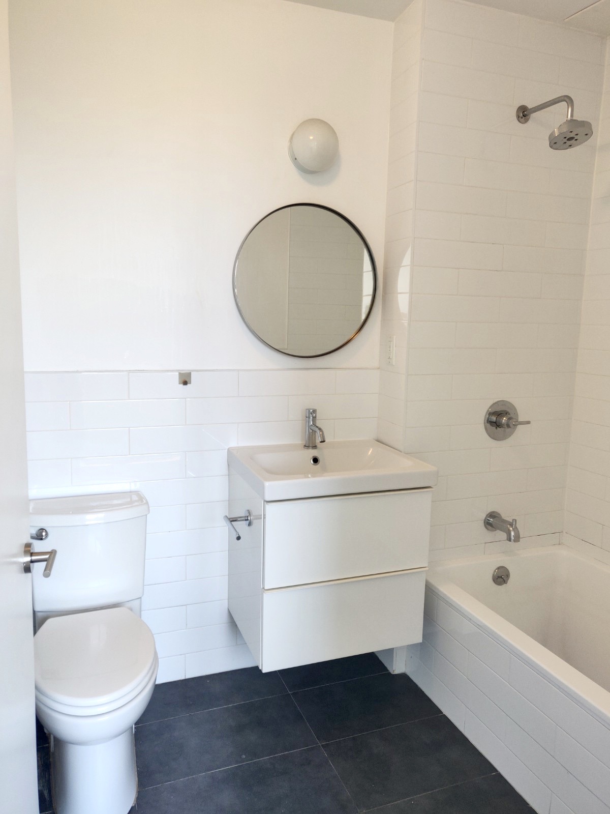 1149 Bedford Avenue, Unit 4A Brooklyn, NY 11216 - Photo 7 of 9 a bathroom with a sink toilet and shower