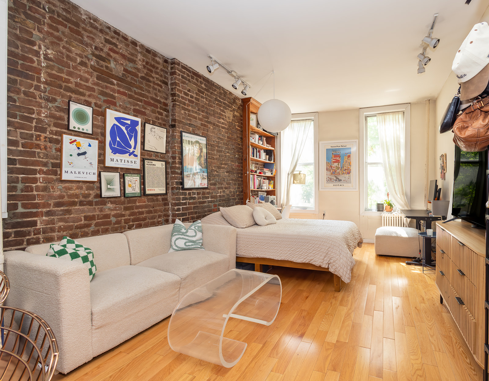 147 Sullivan Street, Unit 2A Manhattan, NY 10012 - Photo 2 of 8 a living room with furniture and a flat screen tv
