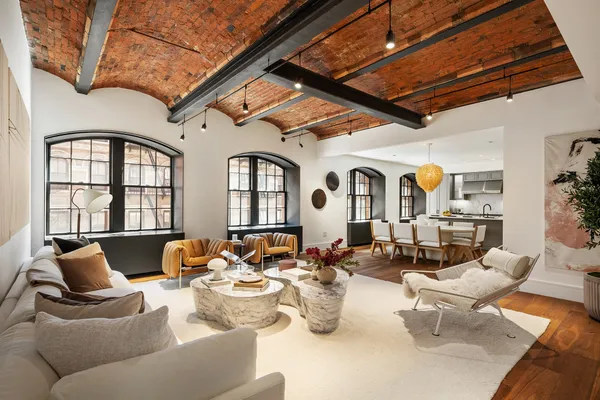 a living room with furniture or couch and a chandelier