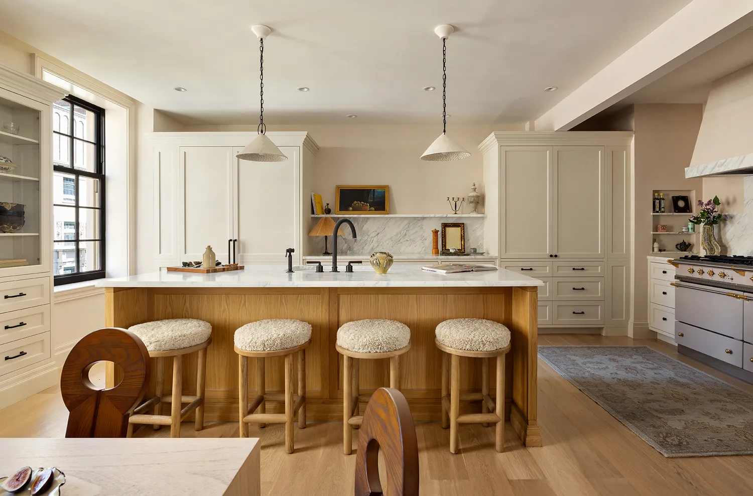 a kitchen with granite countertop a table chairs a sink and a window