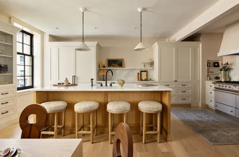 a kitchen with granite countertop a table chairs a sink and a window