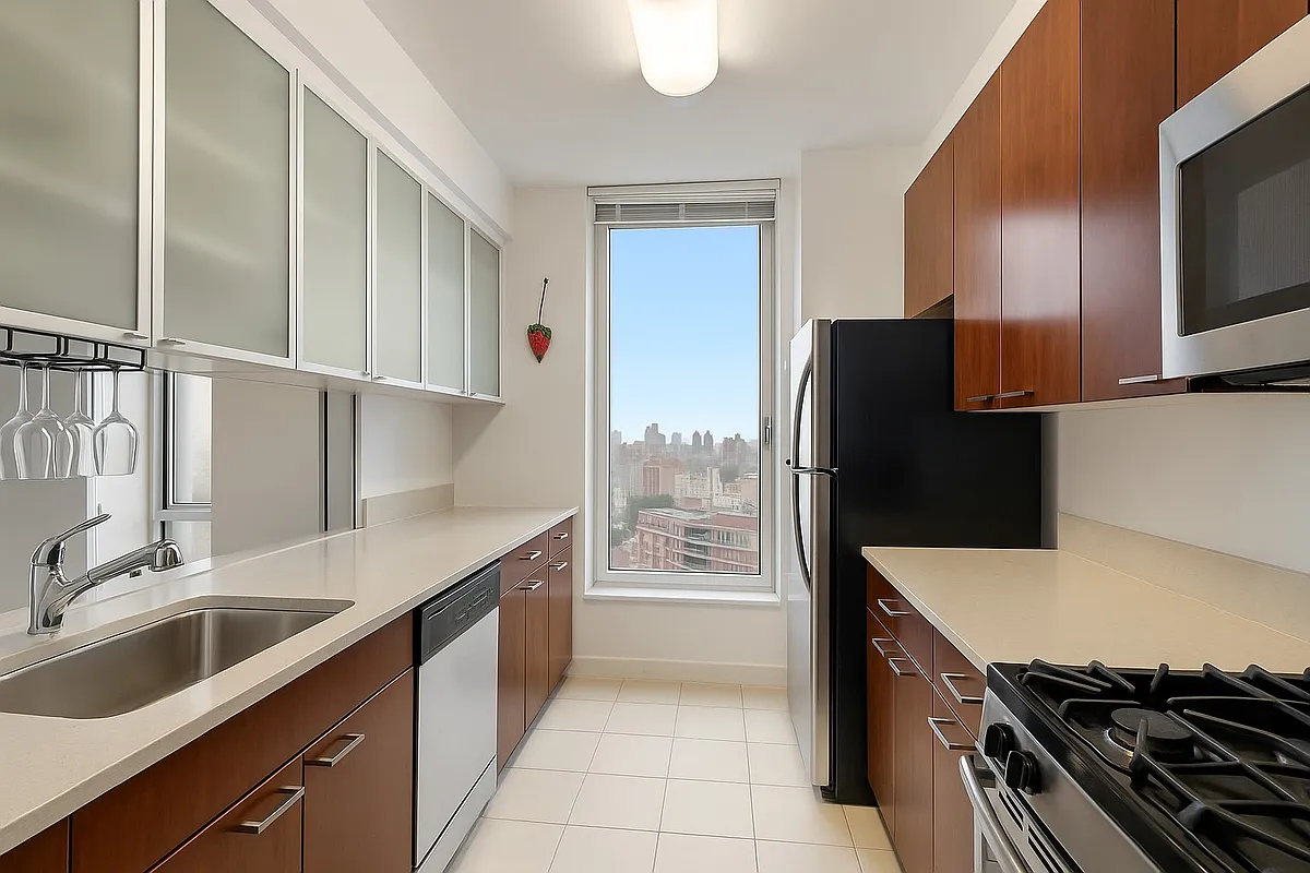 215-217 East 96th Street, Unit 40E Manhattan, NY 10128 - Photo 2 of 7 a kitchen with a sink stove and refrigerator