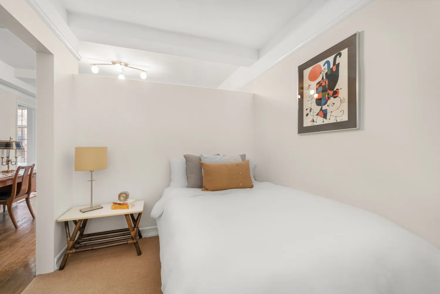 a bedroom with a bed and a lamp on table