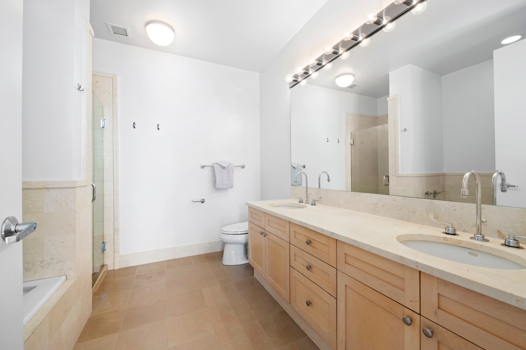 252 7th Avenue, Unit 10T Manhattan, NY 10001 - Photo 7 of 10 a spacious bathroom with a double vanity sink mirror double and shower