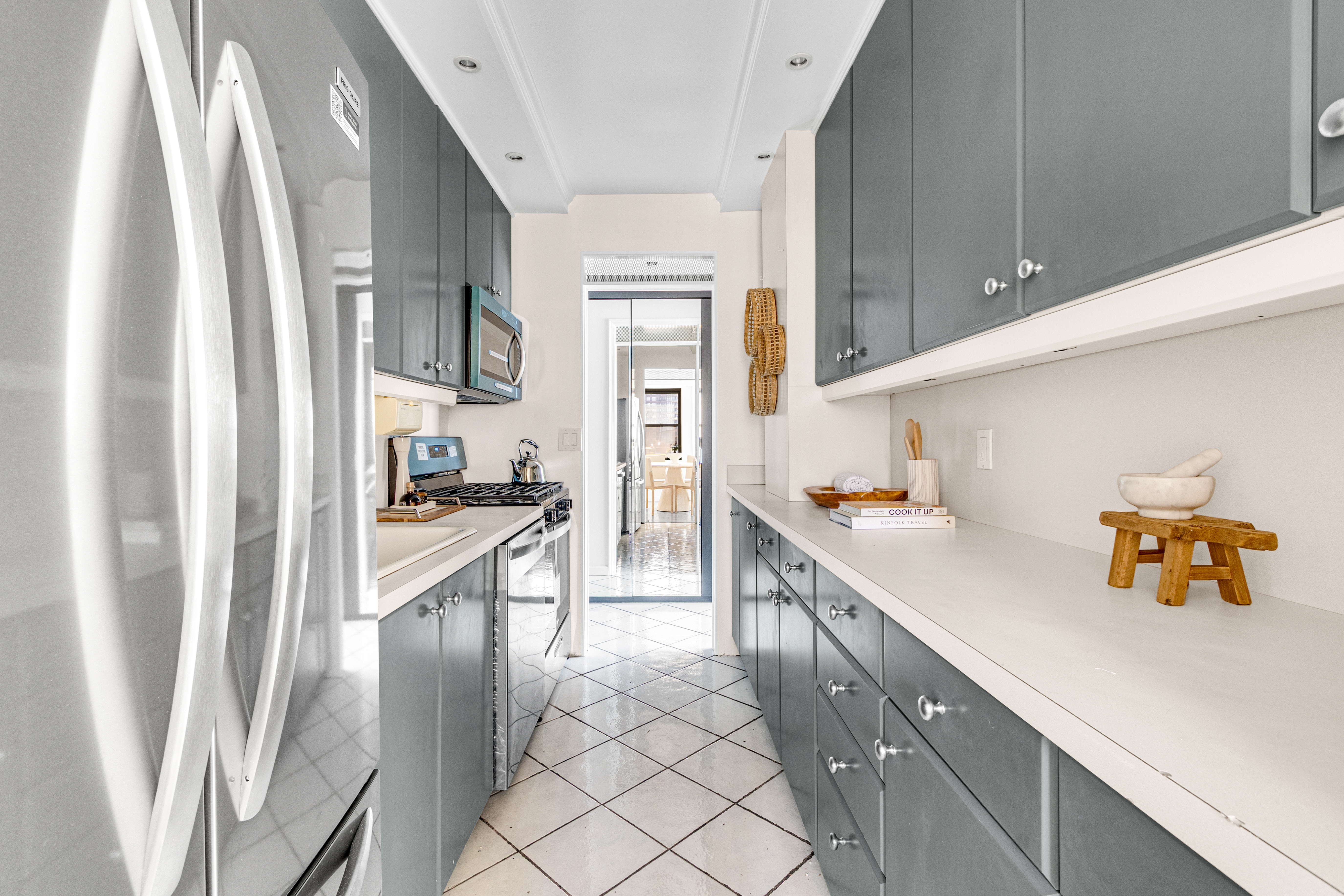 345 East 52nd Street, Unit 10CD Manhattan, NY 10022 - Photo 4 of 14 a kitchen with a sink refrigerator and window