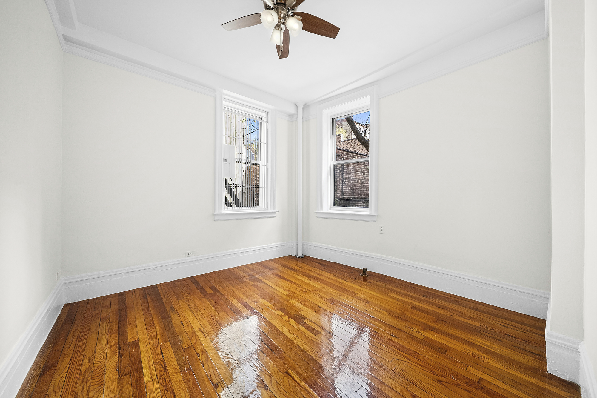 123 Waverly Place, Unit 2D Manhattan, NY 10011 - Photo 2 of 6 an empty room with a window and ceiling fan
