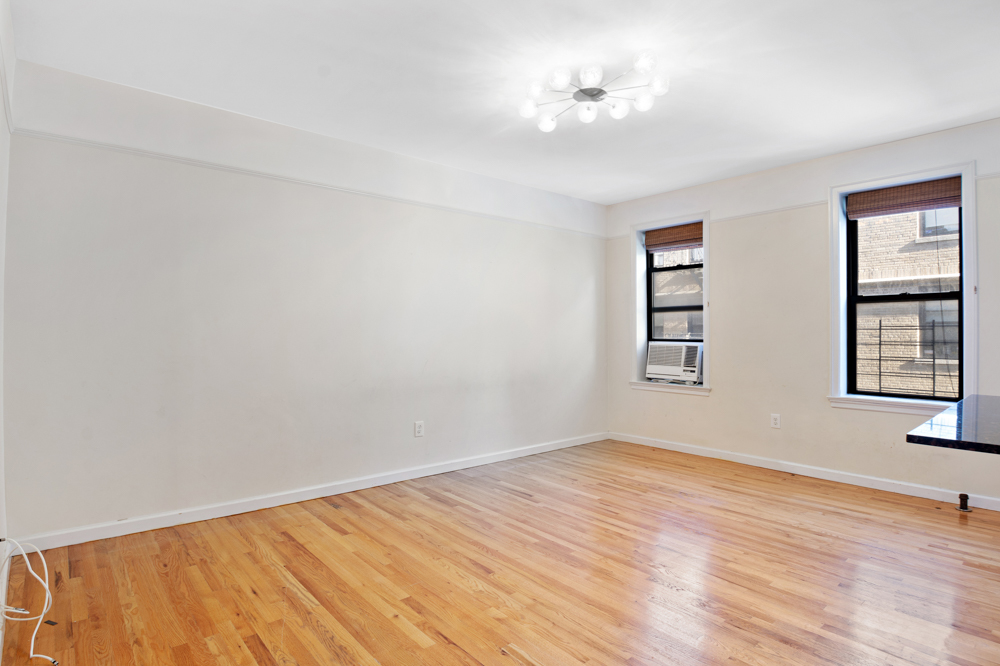 779 Riverside Drive, Unit A50 Manhattan, NY 10032 - Photo 2 of 14 a view of empty room with wooden floor and fan