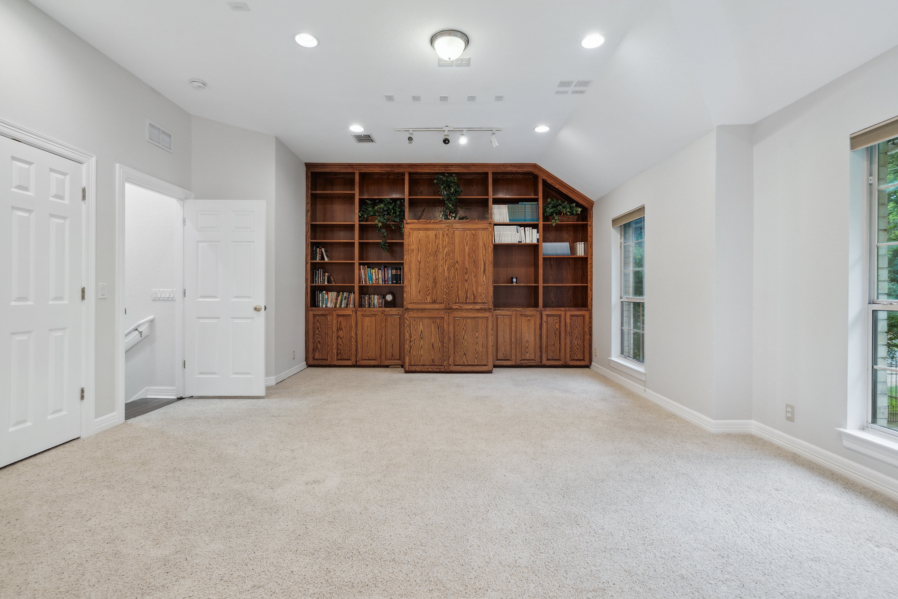 2603 Pearce Road Austin, TX 78730 - Photo 13 of 41 a view of an empty room with closet and wooden shelves