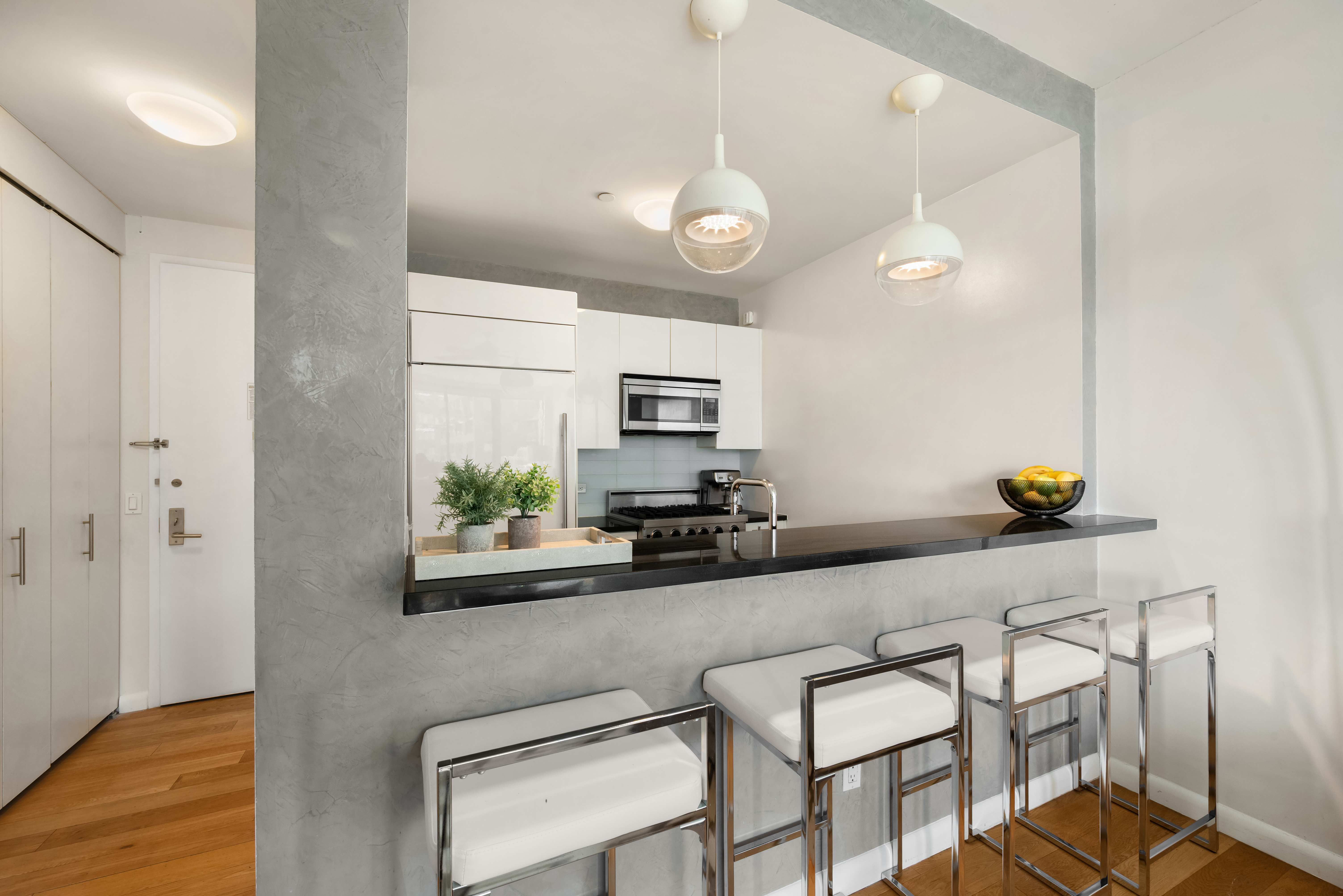 46-30 Center Boulevard, Unit 707 Queens, NY 11109 - Photo 9 of 23 a kitchen with a table chairs and refrigerator