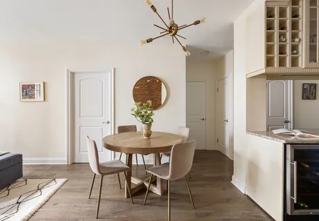 a view of a dining room with furniture and chandelier