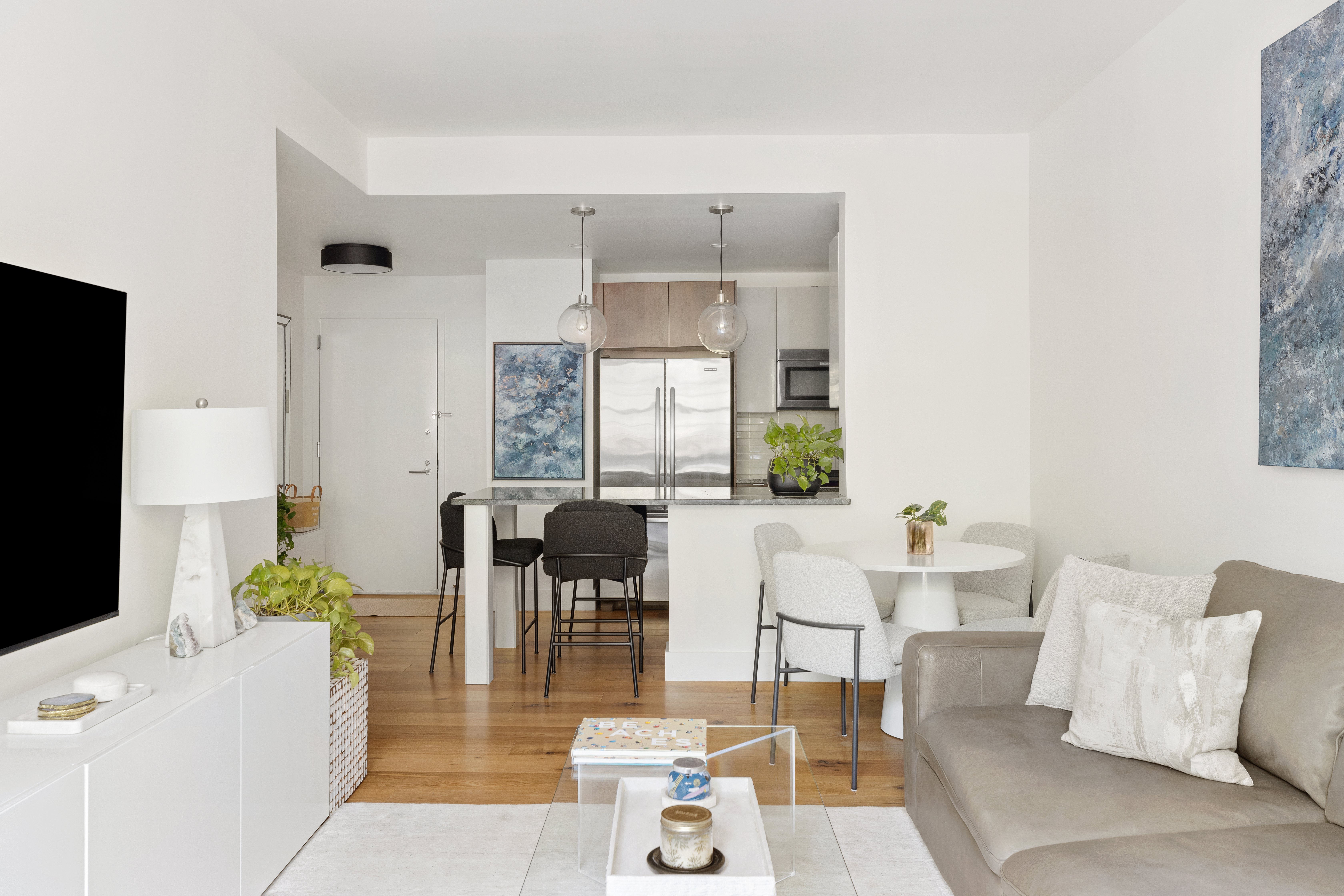 110 Warren Street, Unit B203 Brooklyn, NY 11201 - Photo 3 of 10 a living room with furniture a dining table and a potted plant