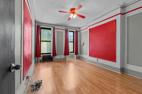 wooden floor in an empty room with a window