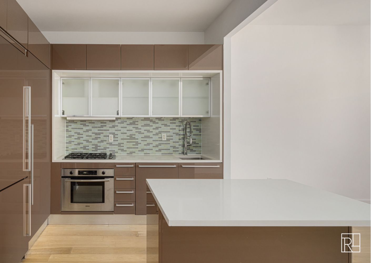 75 Wall Street, Unit 28D Manhattan, NY 10005 - Photo 17 of 35 a kitchen with a stove and a white cabinet