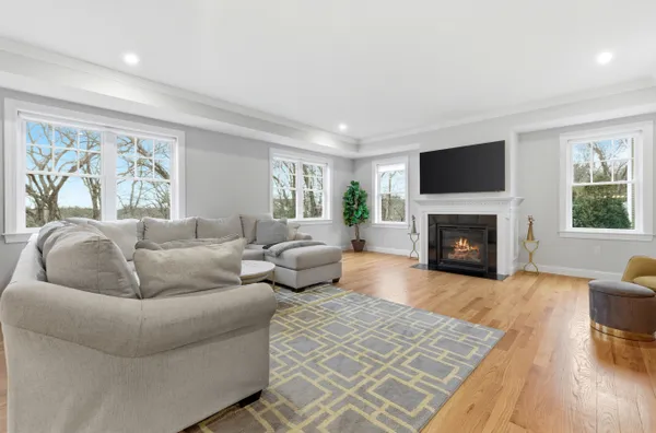 a living room with furniture flat screen tv and a fireplace
