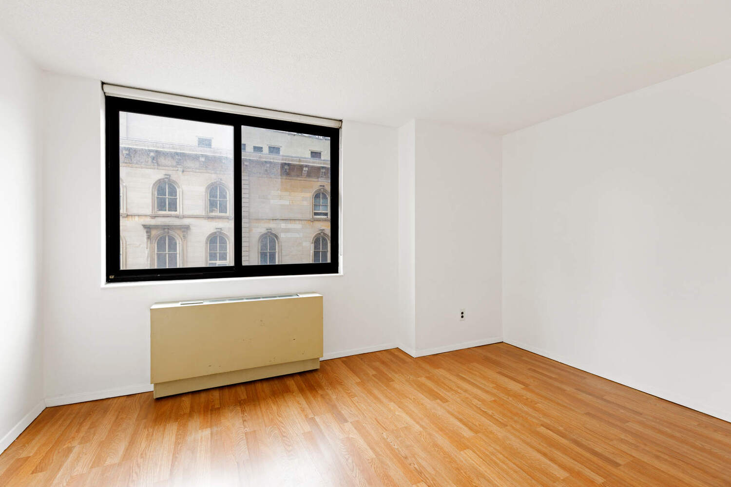 376 Broadway, Unit 6F Manhattan, NY 10013 - Photo 7 of 17 a view of an empty room with wooden floor and a window