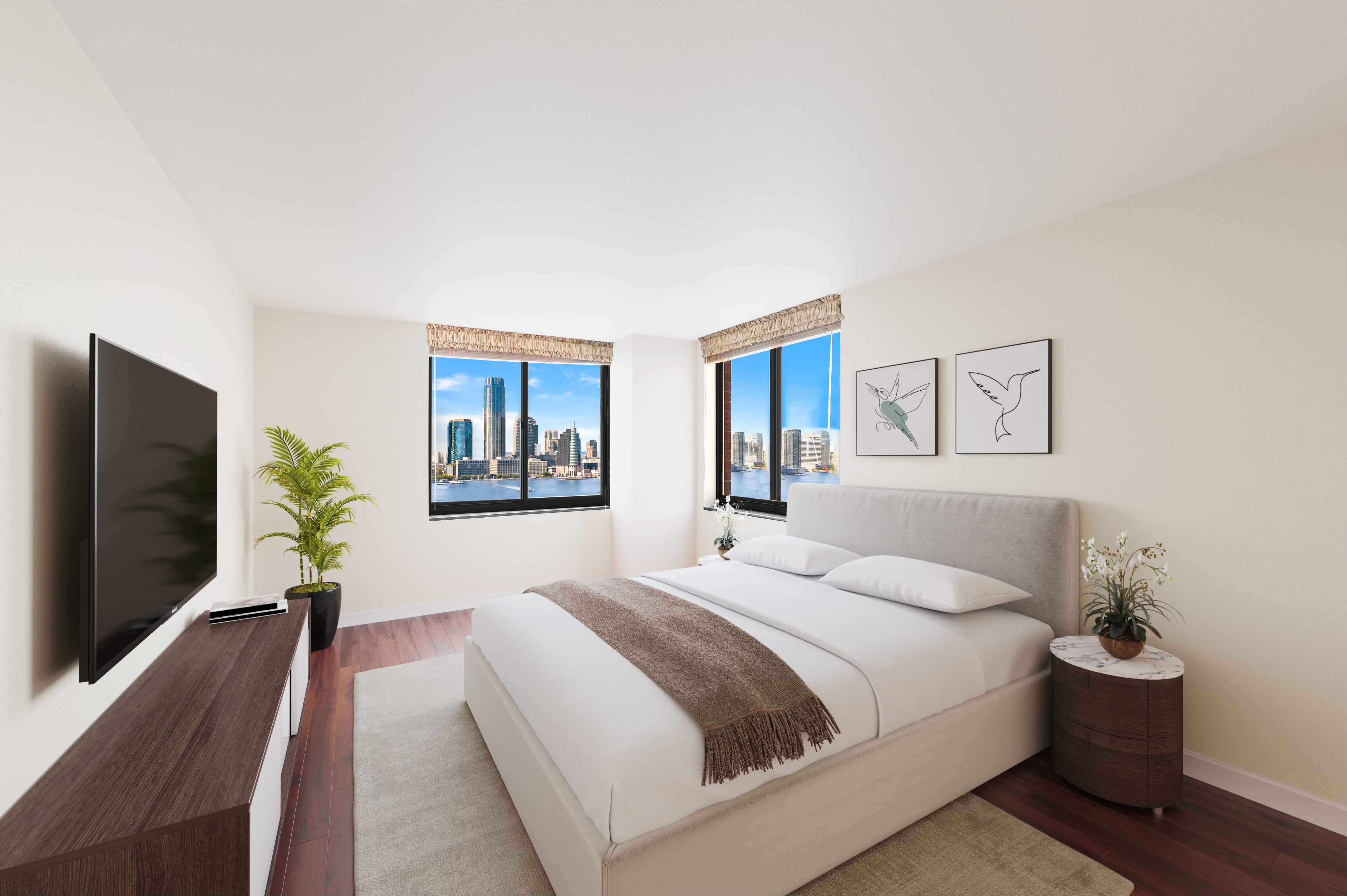 377 Rector Place, Unit 22AB Manhattan, NY 10280 - Photo 3 of 10 a bedroom with a large bed and a flat screen tv