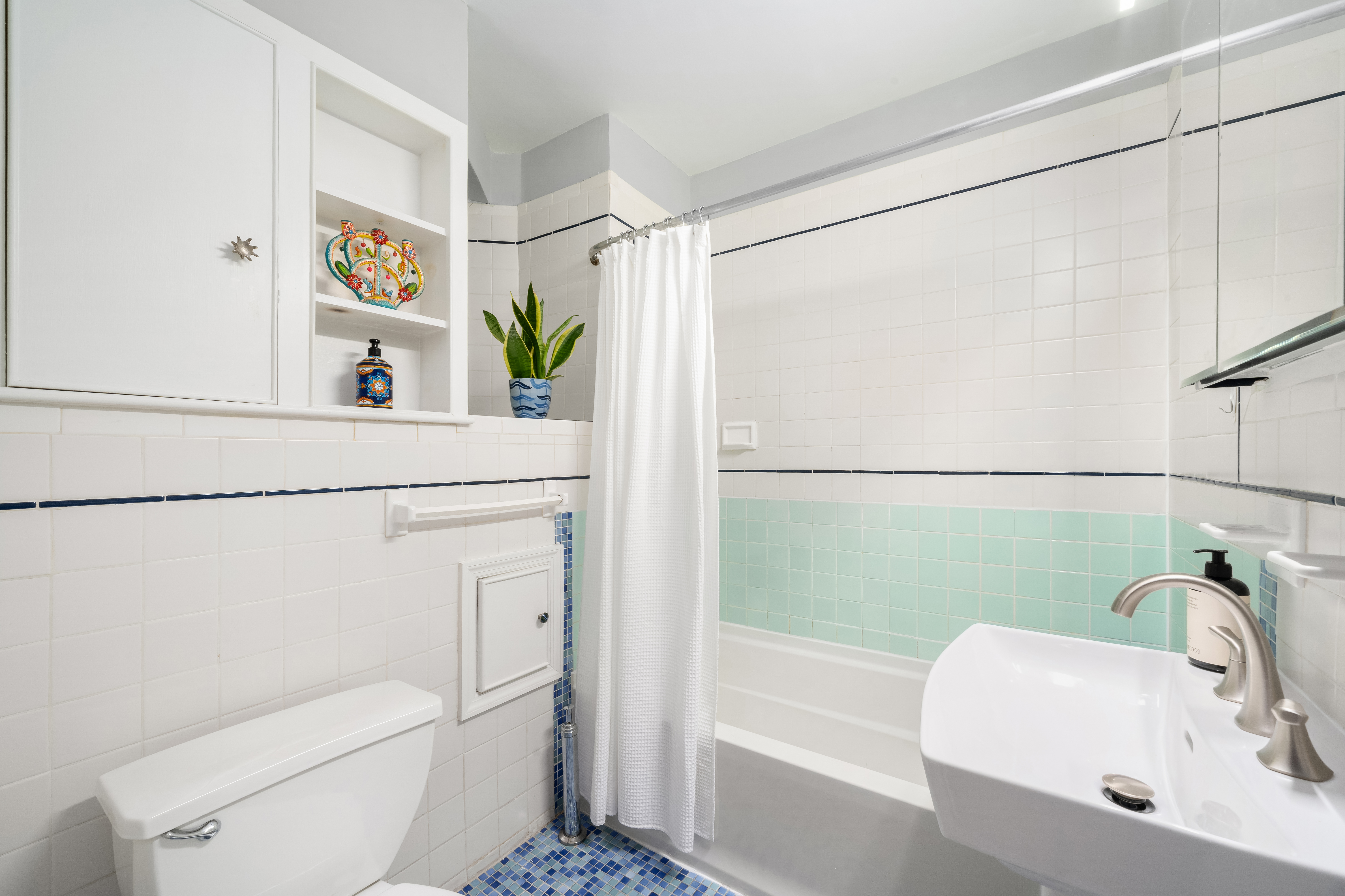 92 Horatio Street, Unit 1J Manhattan, NY 10014 - Photo 10 of 16 a bathroom with a sink a toilet and shower