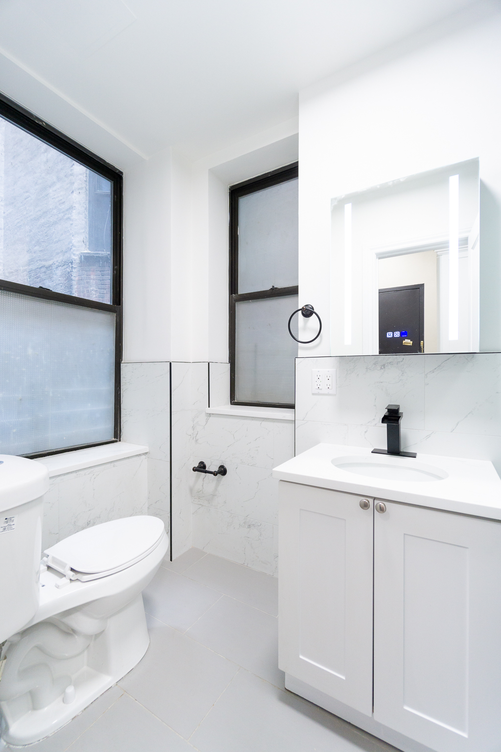 338 East 5th Street, Unit 5 Manhattan, NY 10003 - Photo 7 of 11 a bathroom with a toilet sink a mirror and