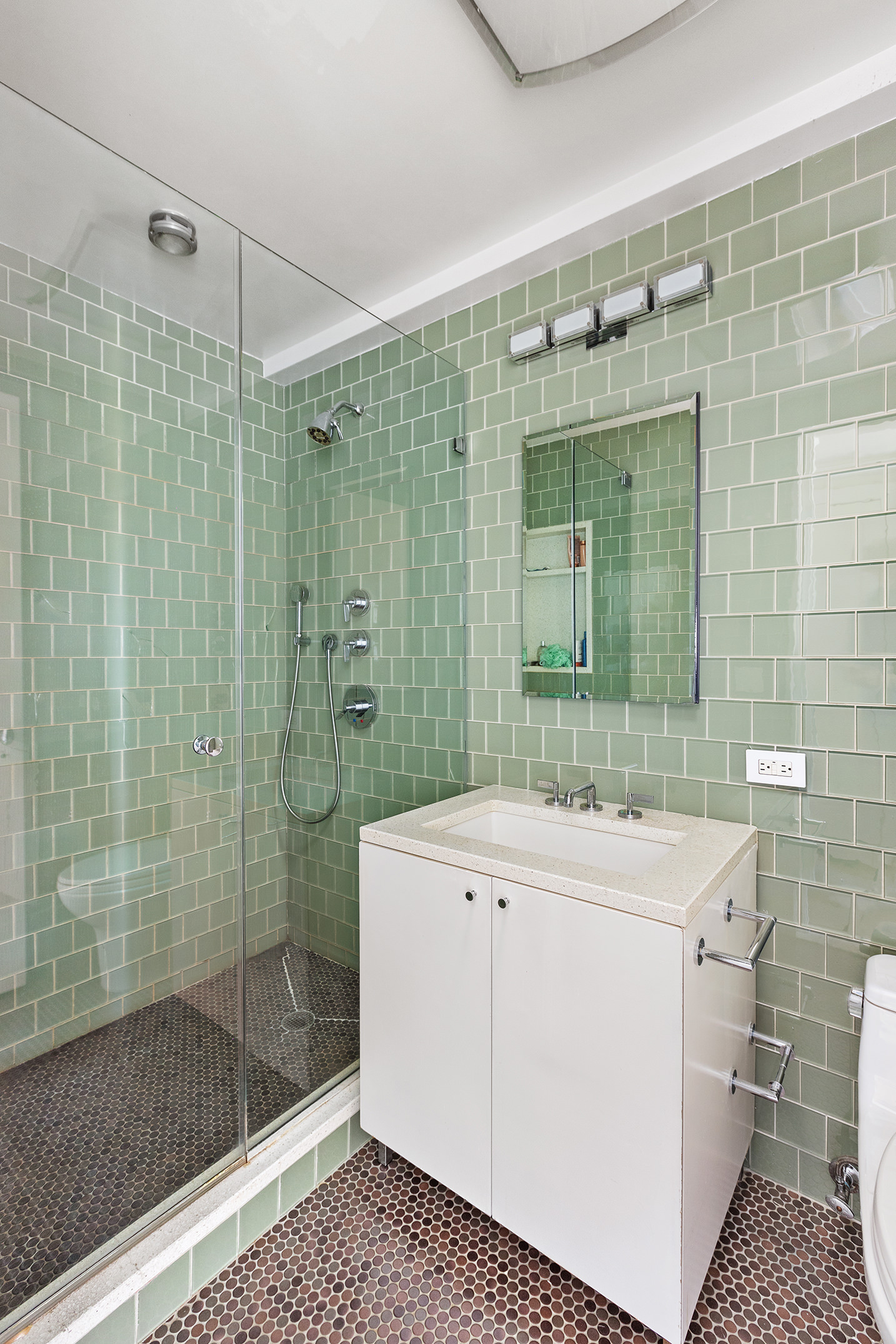 45 East End Avenue, Unit 6/7B Manhattan, NY 10028 - Photo 9 of 17 a bathroom with a sink a toilet and shower