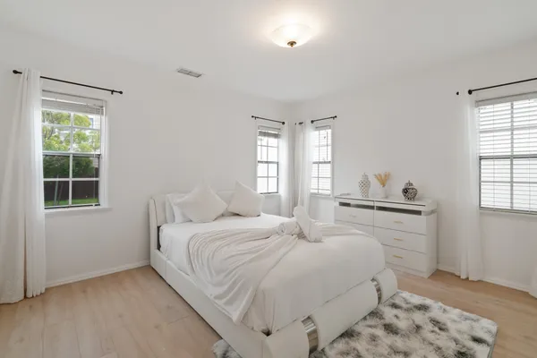 a bedroom with a bed and a window