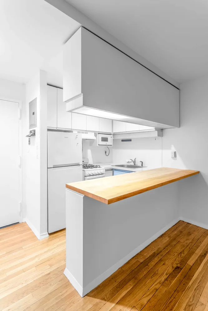a kitchen with stainless steel appliances granite countertop a sink and a refrigerator