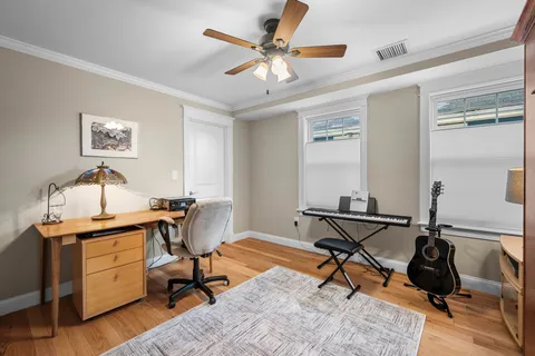 a view of a workspace with furniture and a window