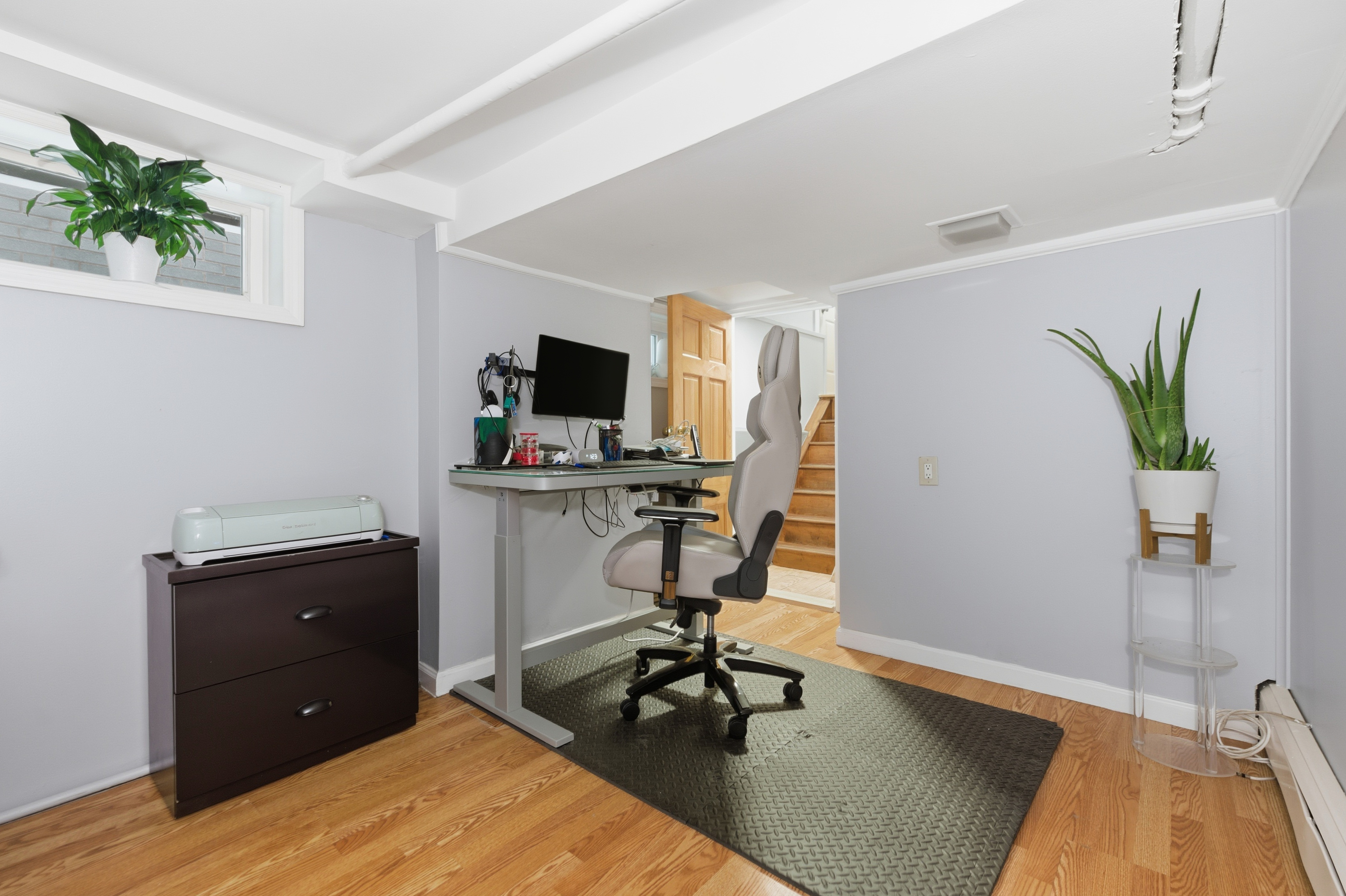 150-22 114th Road Queens, NY 11434 - Photo 11 of 22 a workspace with furniture and wooden floor
