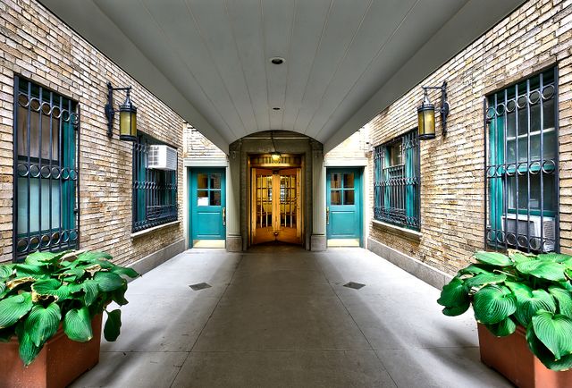 325 West 45th Street, Unit 108 Manhattan, NY 10036 - Photo 10 of 12 a view of a lobby with chair and flower plants