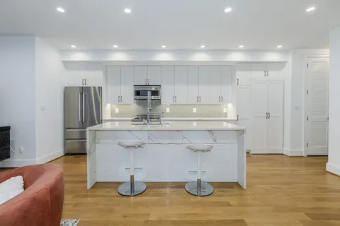 a kitchen with kitchen island cabinets and refrigerator