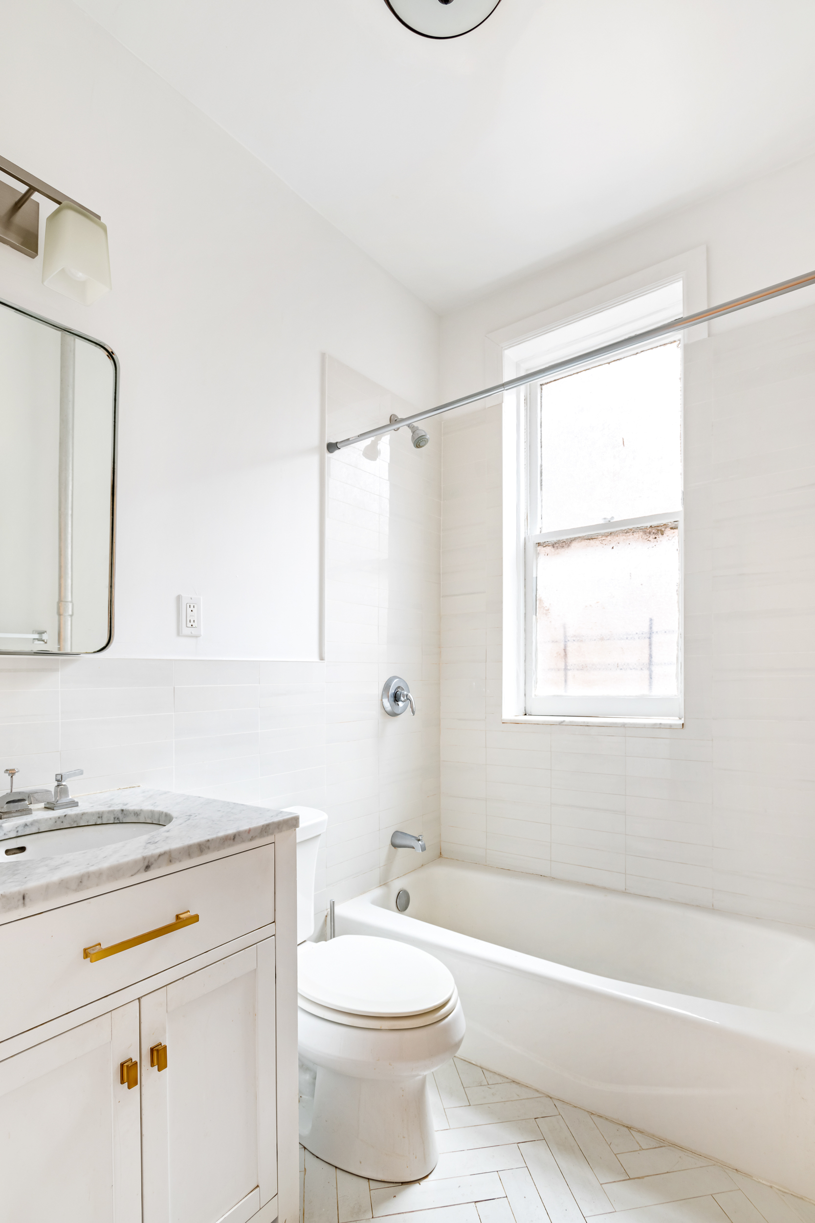 50 East 96th Street, Unit 5D Manhattan, NY 10128 - Photo 3 of 5 a bathroom with a granite countertop sink toilet a mirror and shower
