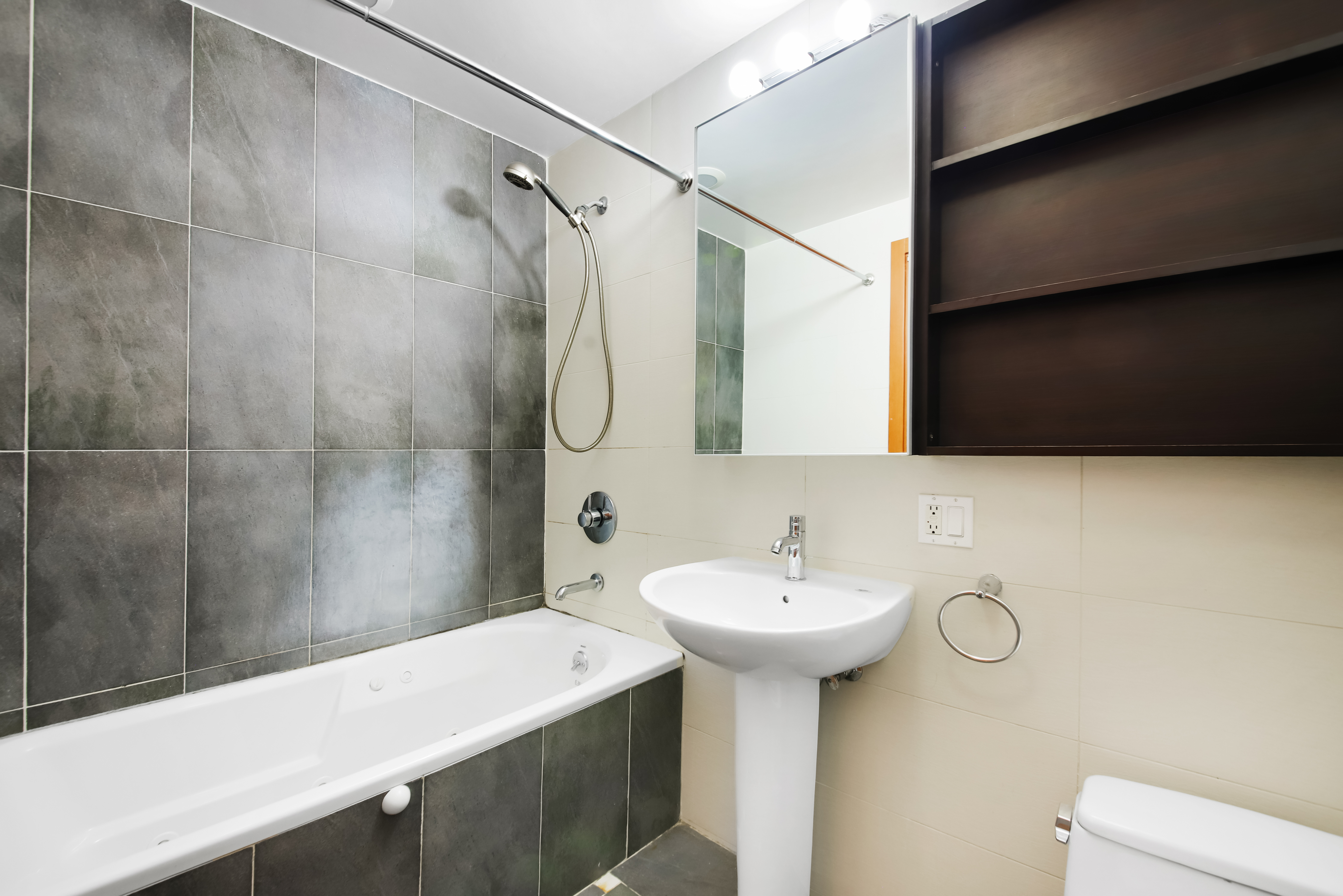 3112 Emmons Avenue, Unit 206 Brooklyn, NY 11235 - Photo 5 of 10 a bathroom with a sink a toilet and shower