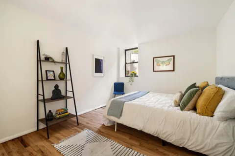 a bedroom with a bed and a window