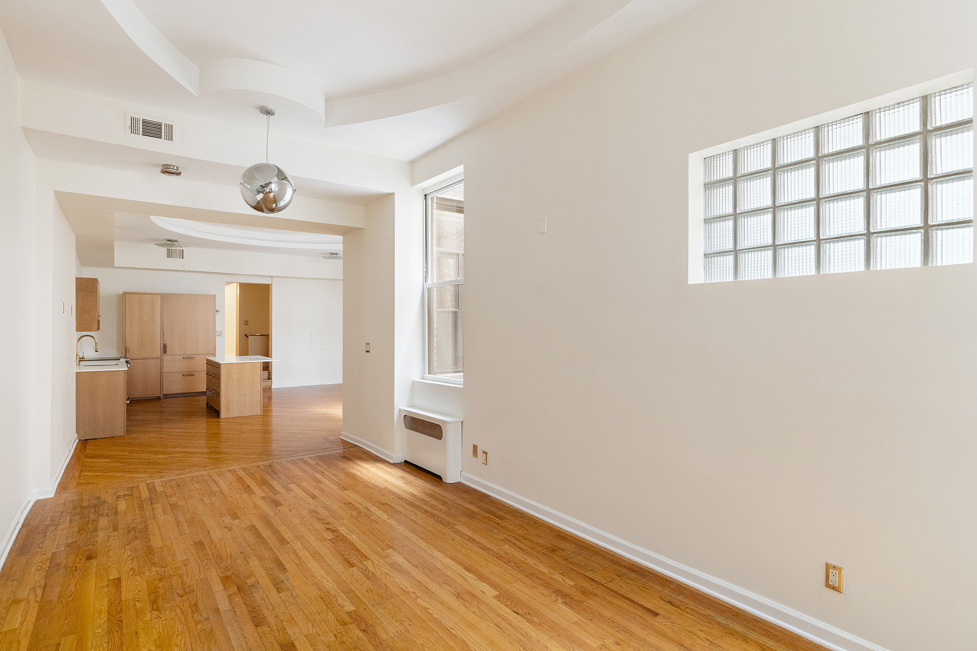23 East 81st Street, Unit 1 Manhattan, NY 10028 - Photo 11 of 23 a view of an empty room with wooden floor and a window