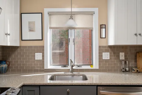 a kitchen with a sink and a window