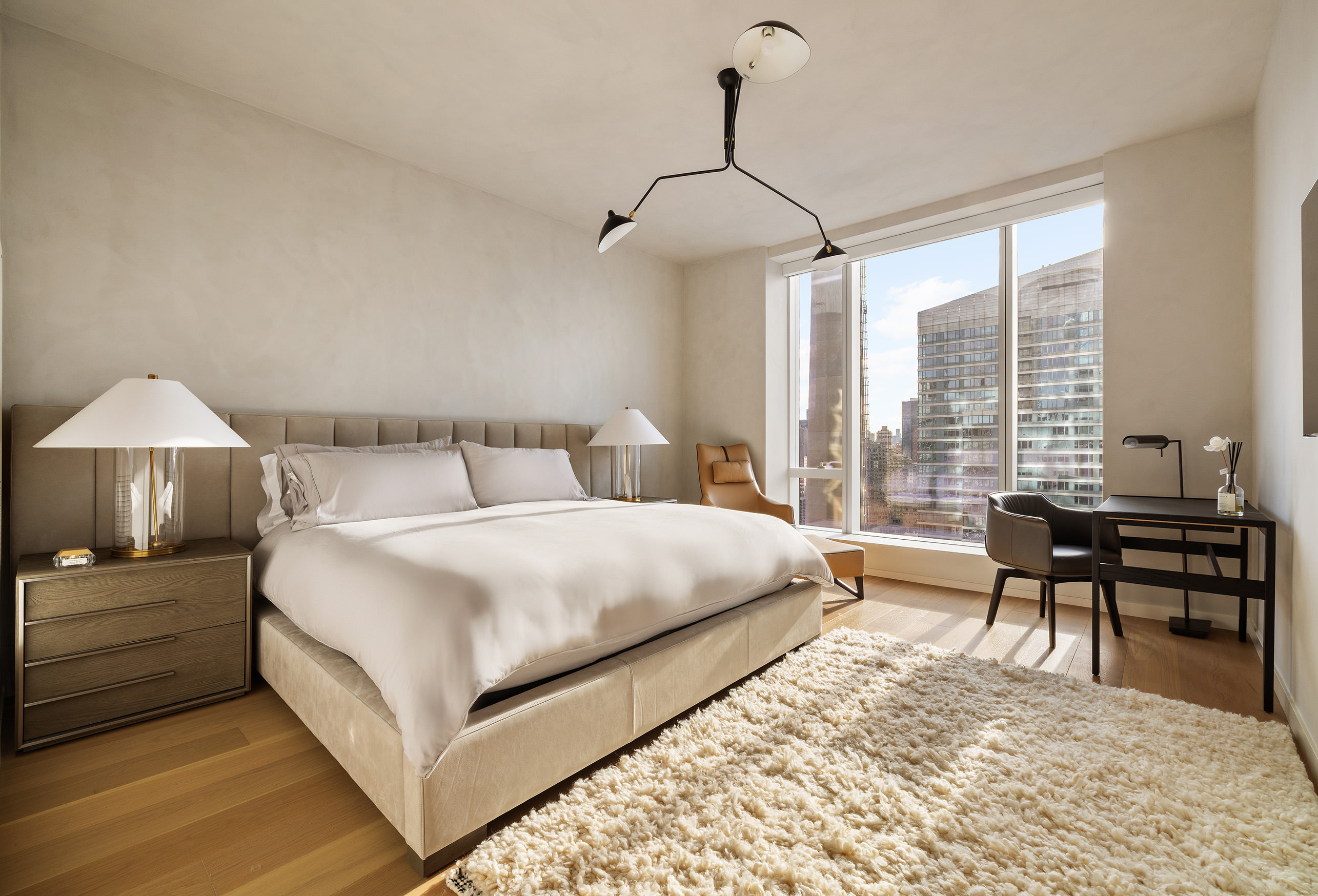 1 West End Avenue, Unit 25F Manhattan, NY 10023 - Photo 6 of 15 a bedroom with a bed and a table