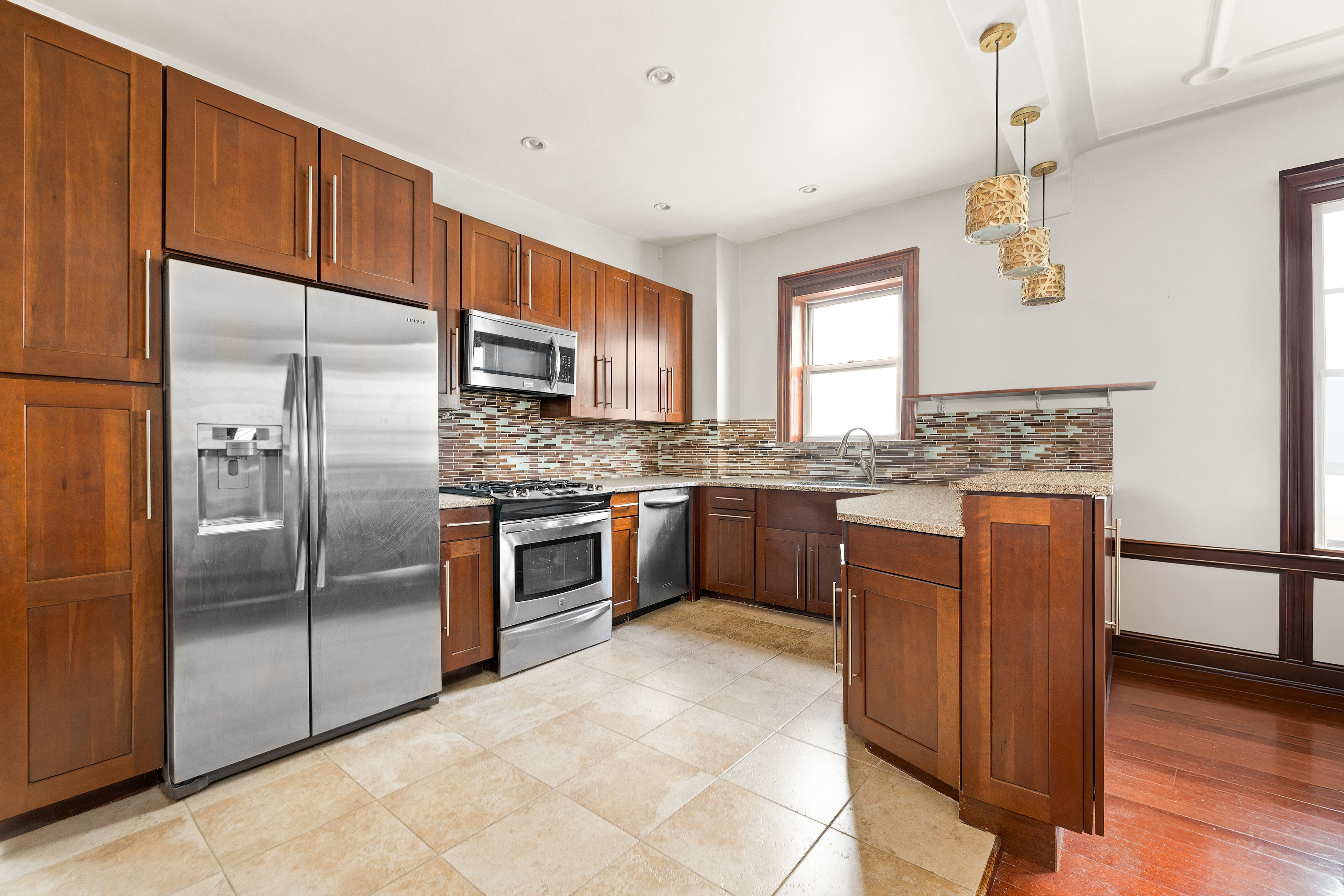 742 44th Street Brooklyn, NY 11220 - Photo 2 of 23 a kitchen with stainless steel appliances granite countertop a refrigerator and a stove top oven